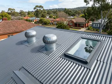 Roof whirlybirds and a skylight on a new corrugated steel roof